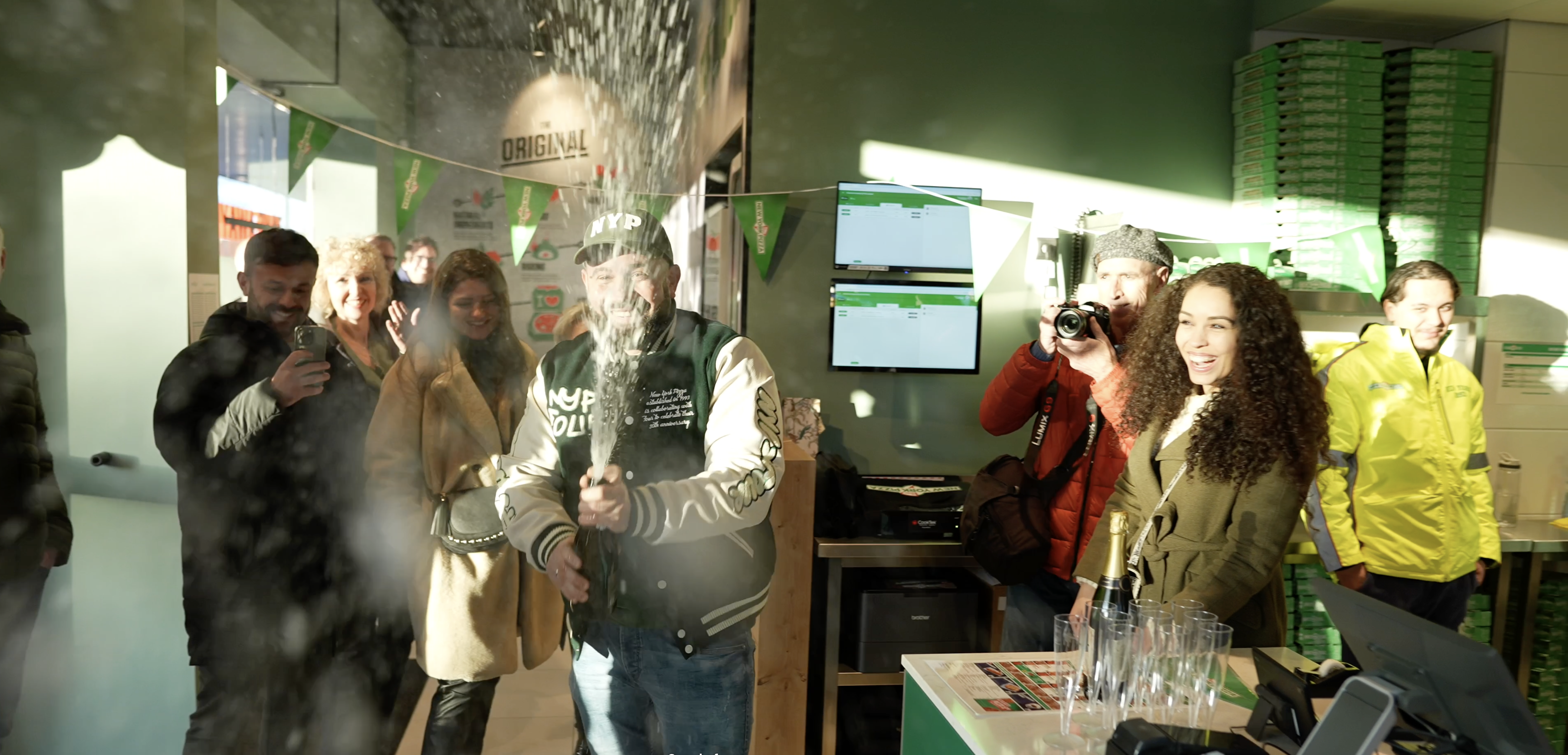 Champagne Celebration Image: Denis Sprays Bubbly in Joyful Triumph Towards the Camera.