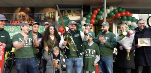 Grand Opening Celebration: Denis and Family Joyfully Cut the Ribbon at New York Pizza's Newest Store.