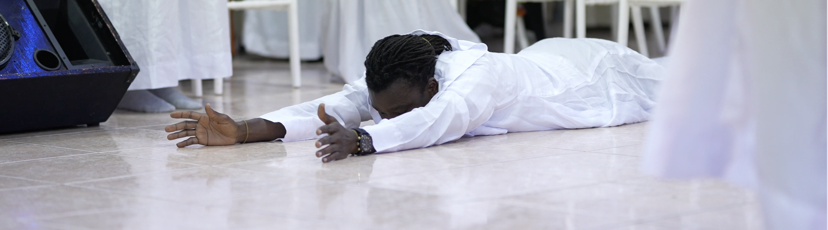 Profound Moment: Man Laying on the Ground, Touched by the Presence of Jesus.